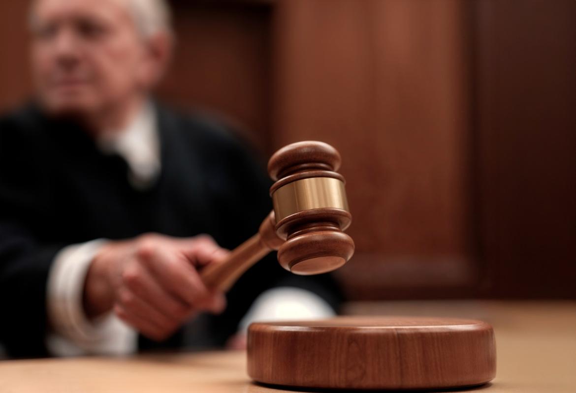 Close-up of a judge banging a gavel in a courtroom.